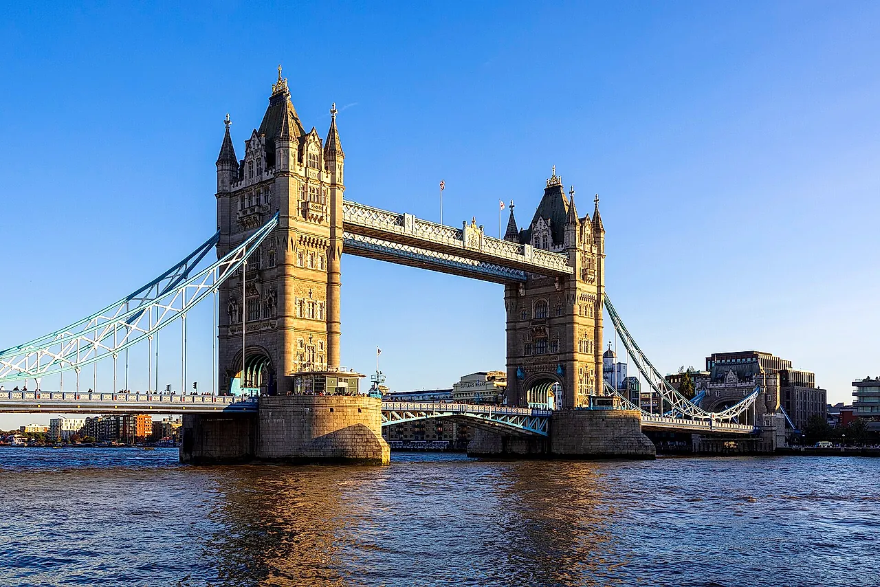Tower Bridge seen from Tower Wharf on the Thames, with its two Gothic towers and blue suspension chains