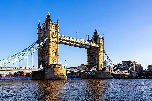 Tower Bridge seen from Tower Wharf on the Thames, with its two Gothic towers and blue suspension chains